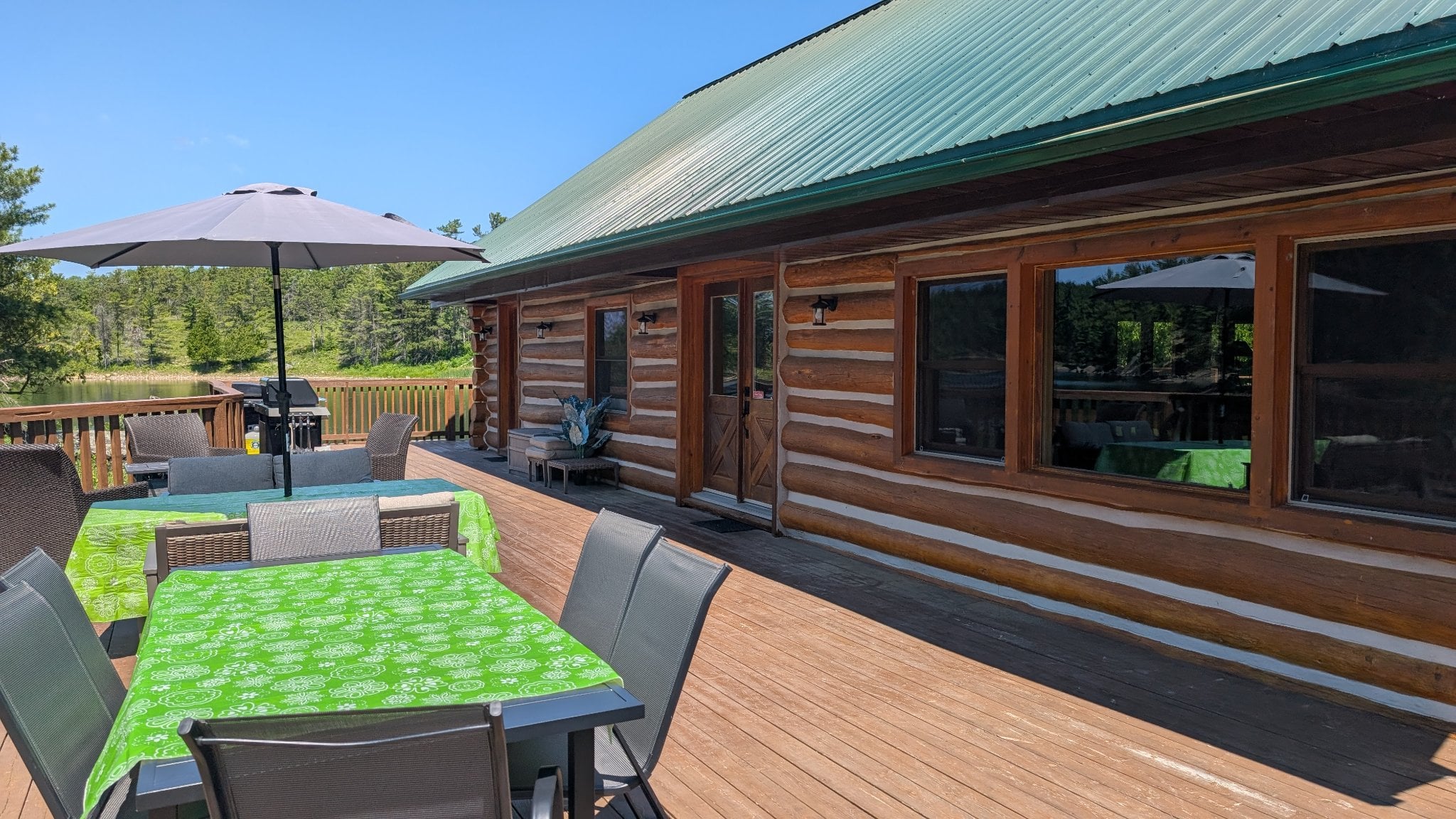 Rainbow Lodge log cabin exterior with spacious deck and river views